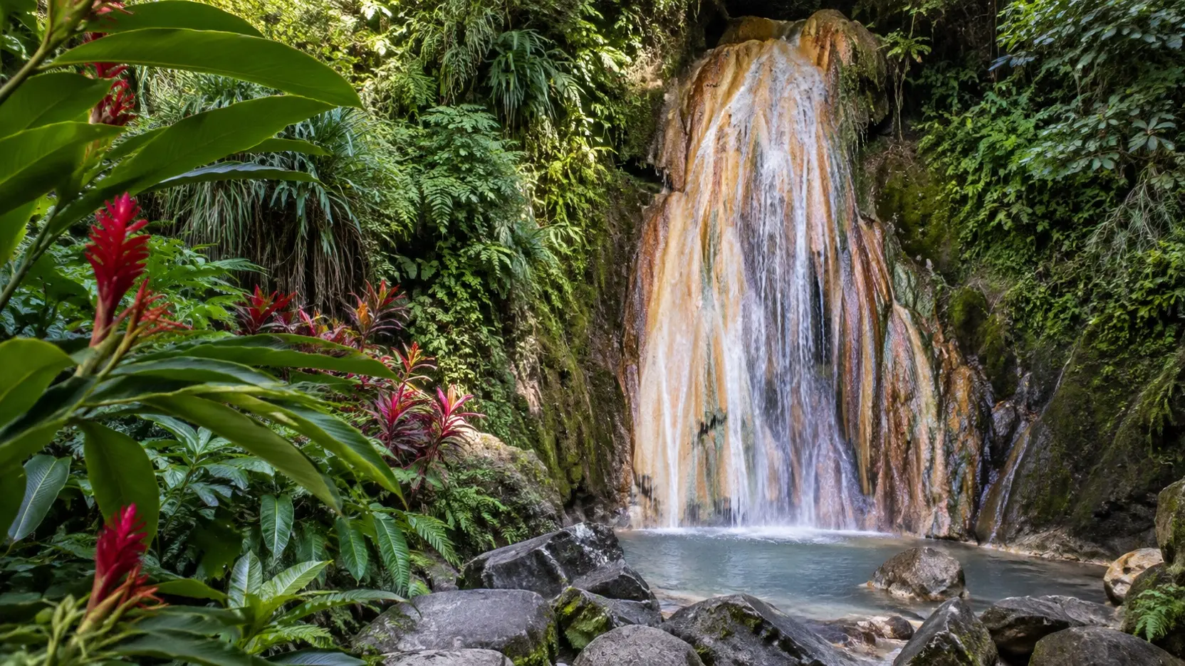 Mineral-streaked Diamond Falls surrounded by tropical plants in Saint Lucia