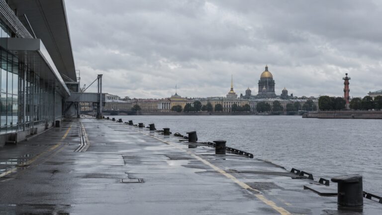 Empty cruise berth at St Petersburg waterfront under gray sky