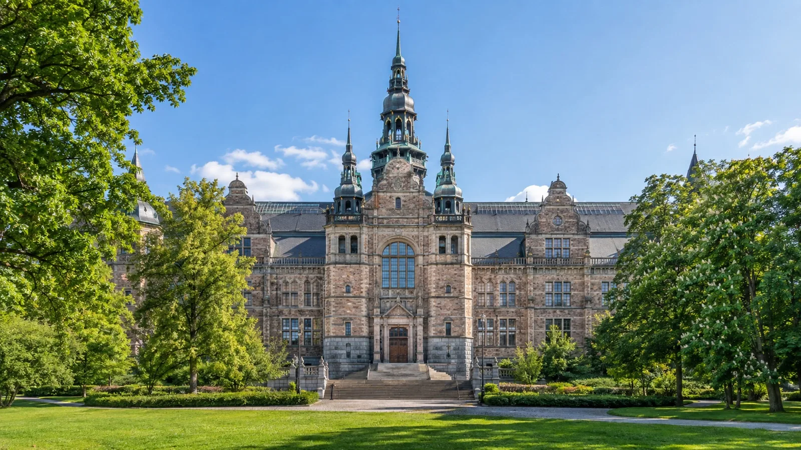 Nordic Museum facade amid summer trees on Stockholm Djurgården island
