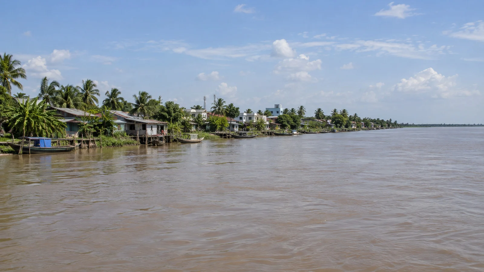 Wide flat Tiền River flowing past Tân Châu in the Mekong Delta