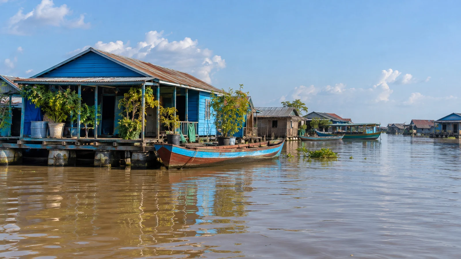 floating wooden houses and moored boats in a Tonle Sap Lake village in Cambodia, no people