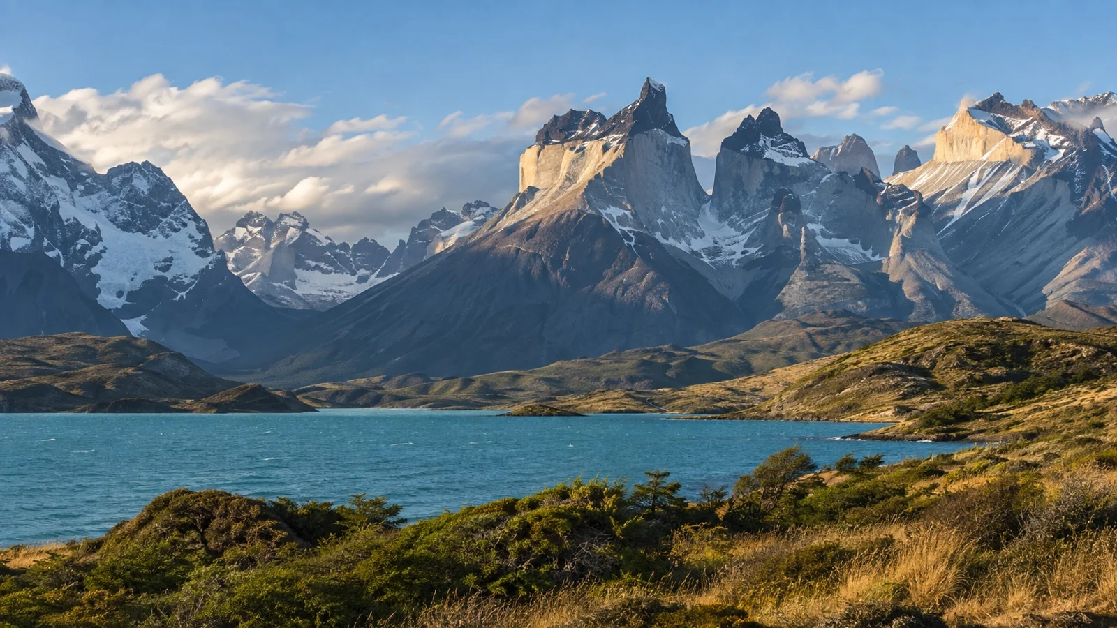Granite towers of Torres del Paine above a Patagonian lake and steppe