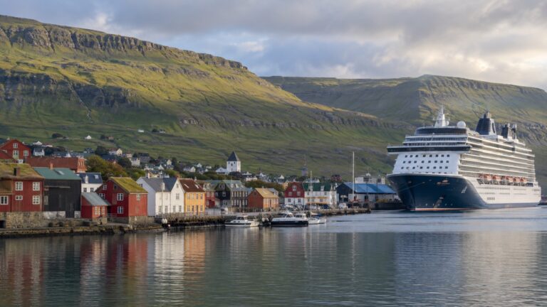 Cruise ship in Tórshavn harbor among Faroese hills