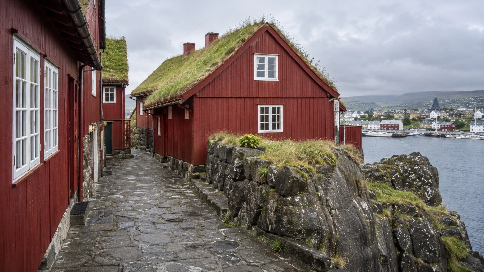 Traditional red timber houses with turf roofs in Tinganes