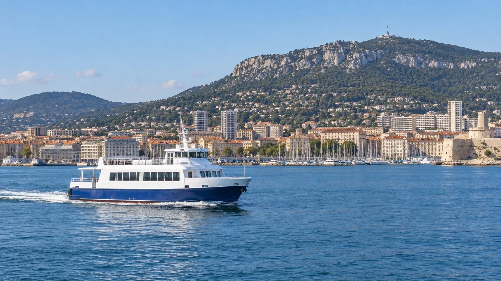 Passenger ferry crossing Toulon Bay with Mont Faron beyond