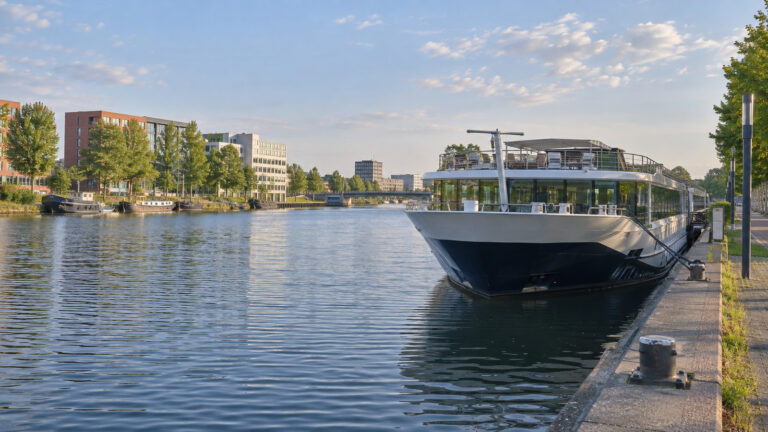 River cruise vessel at an outer Utrecht canal berth beyond the old center