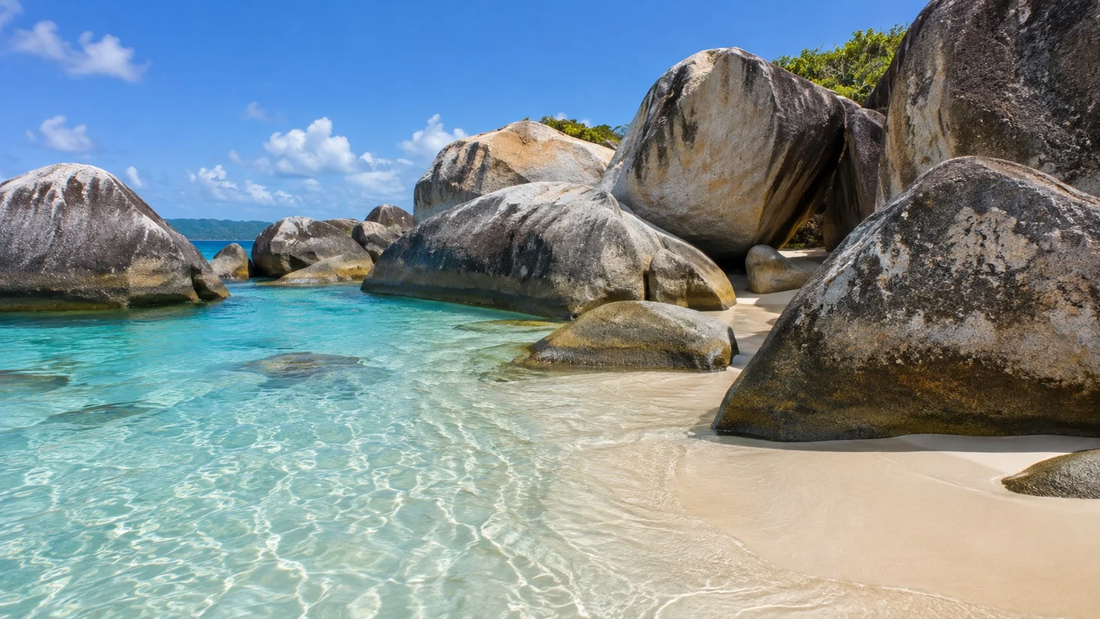 Enormous granite boulders beside turquoise water at The Baths on Virgin Gorda