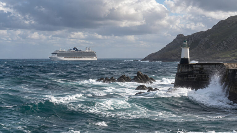 Cruise ship waiting offshore outside a windy port entrance