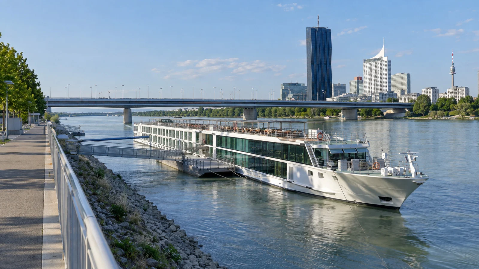 a river cruise ship at a modern Danube berth near Vienna’s Reichsbrücke bridge