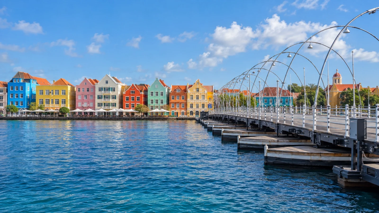 Otrobanda waterfront and the Queen Emma pontoon bridge, colorful colonial hotel facades across the harbor