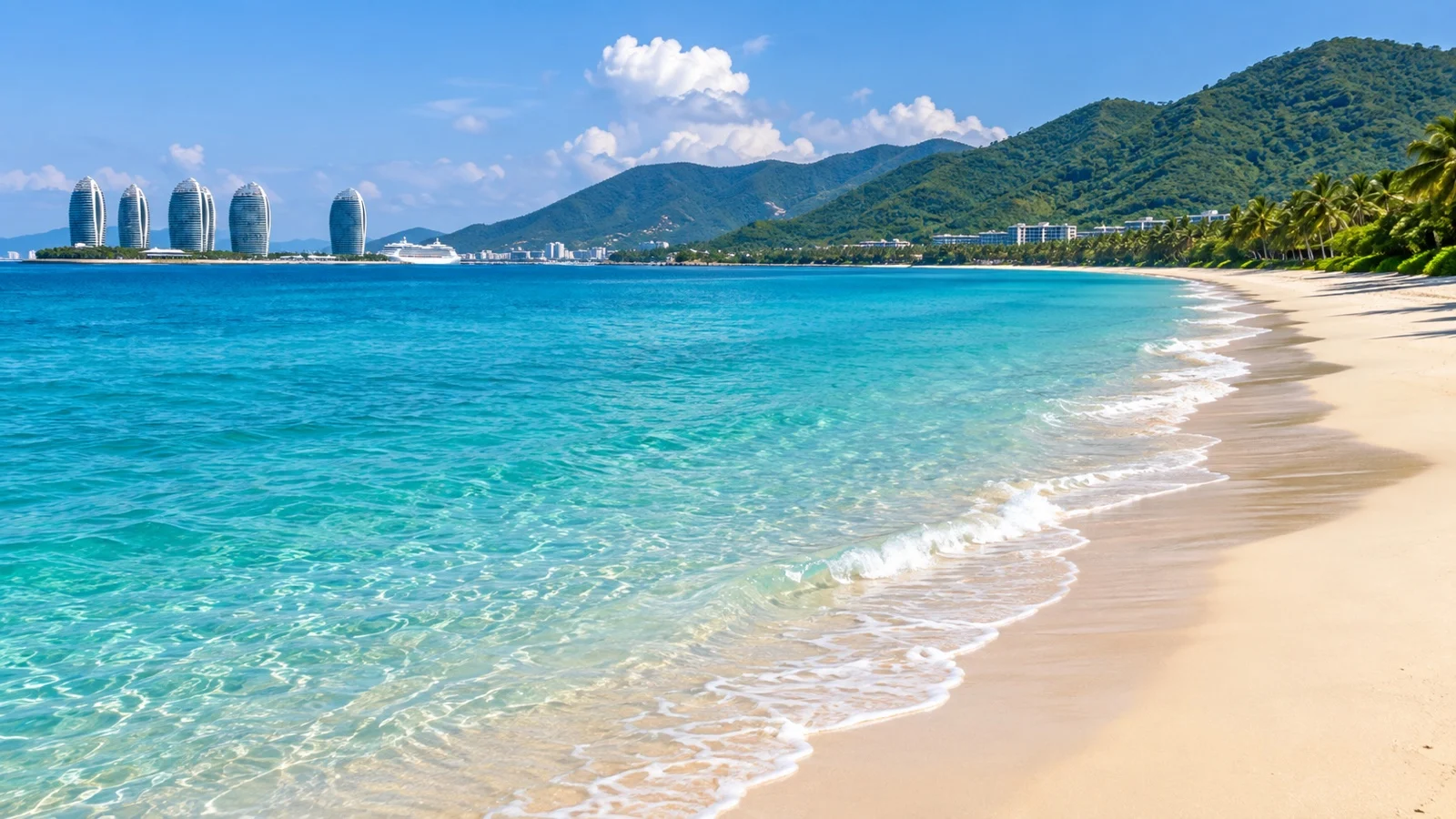 Long tropical beach and green hills at Yalong Bay