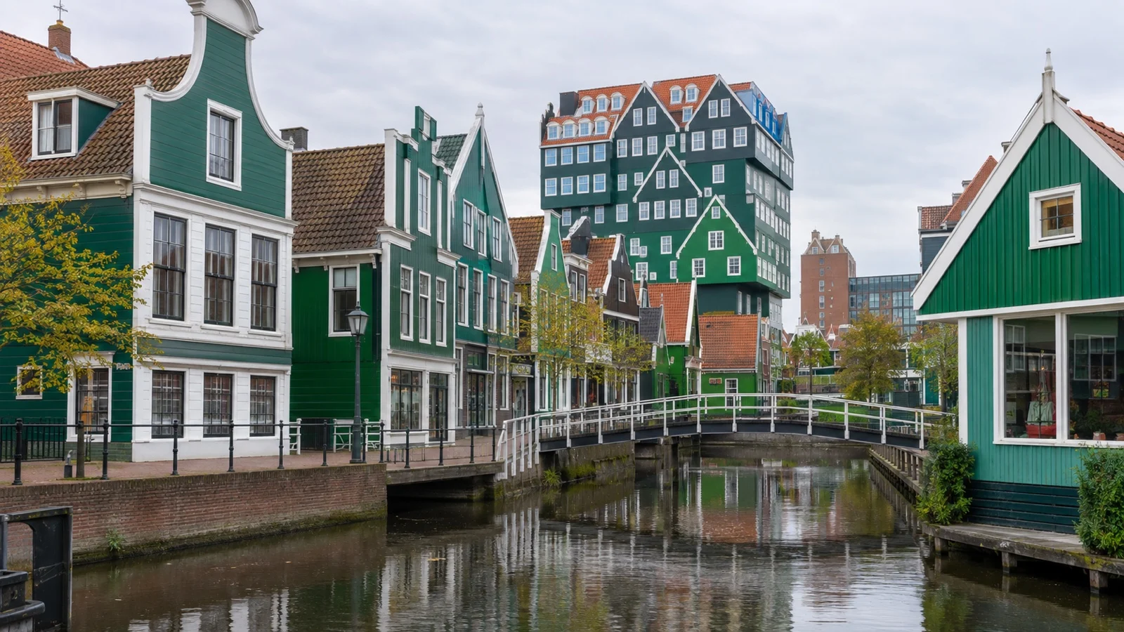 Zaandam town center with green wooden facades and a canal bridge
